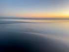 Abstract blur of sunset over water-covered beach. Art Print